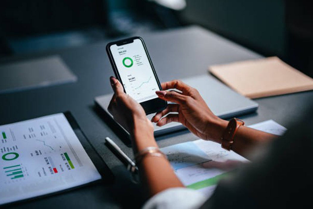 Man Holding Phone Looking at his application